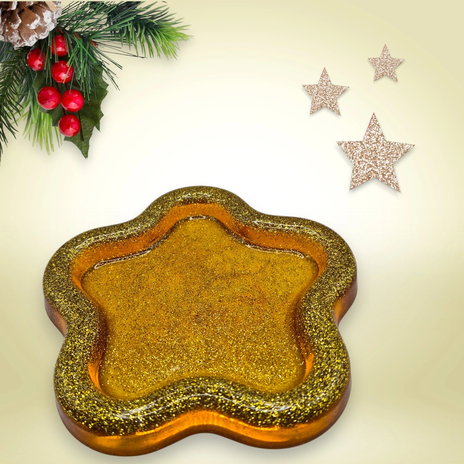 vide poche en forme d'étoile en résine pailletée dorée posée sur un fond décoratif